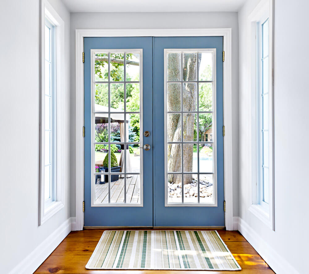 Modern, sky blue patio doors with square grilles.