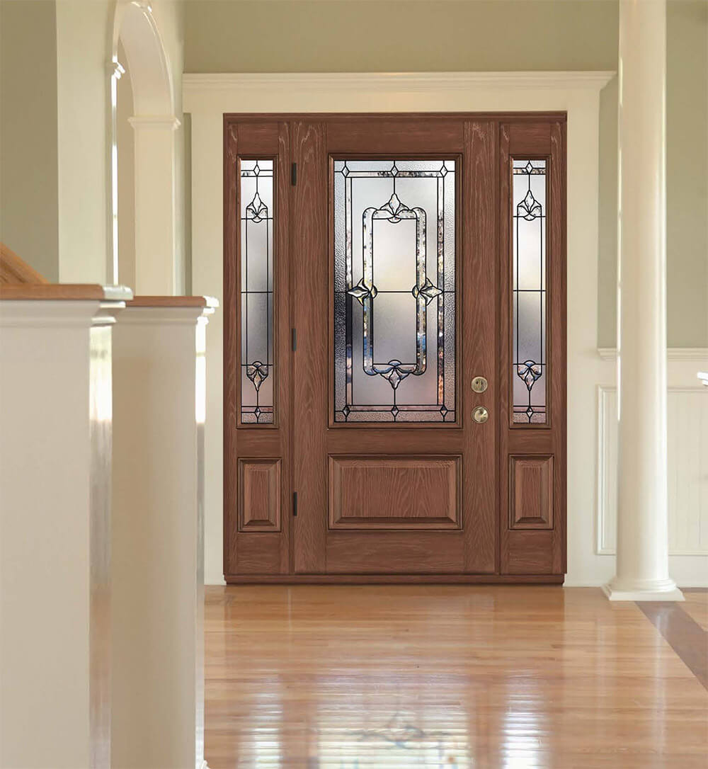 View from inside a home of a modern front door with custom glass inserts