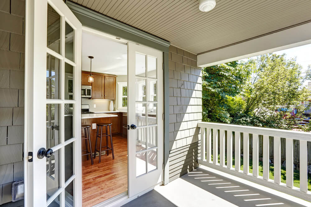 Patio Doors opening up from a kitchen to an enclosed deck.