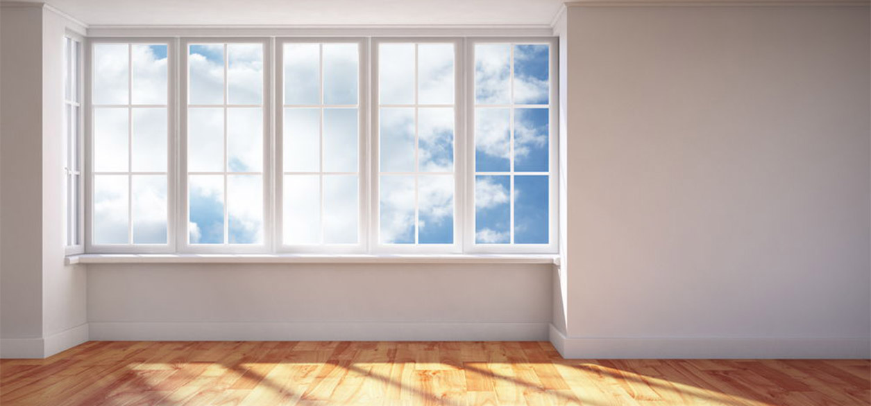 A large pvc casement window in an empty bedroom.