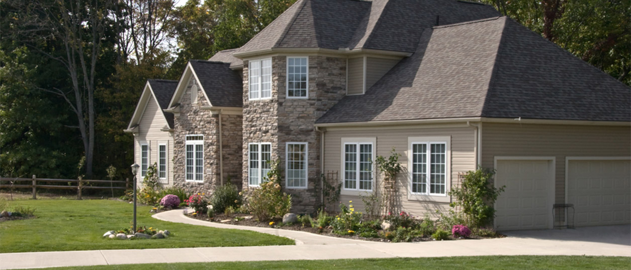 Side of house with beautiful windows and siding.