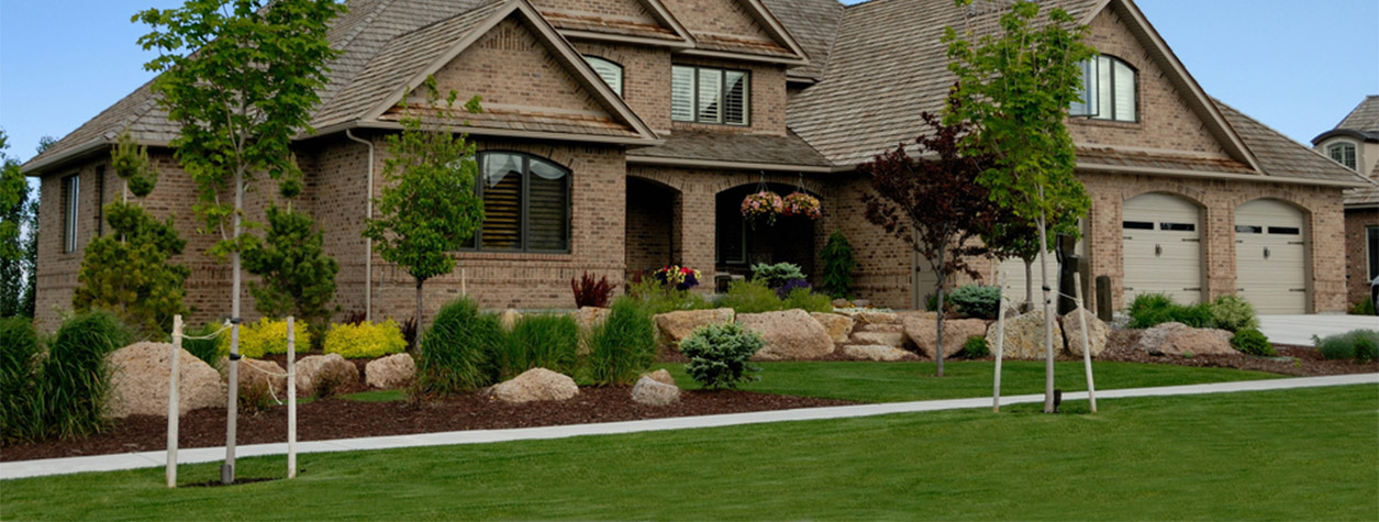 Picture of brown house from outside during summer.