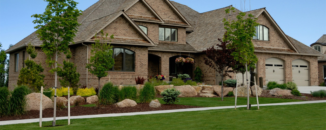 Picture of brown house from outside during summer.