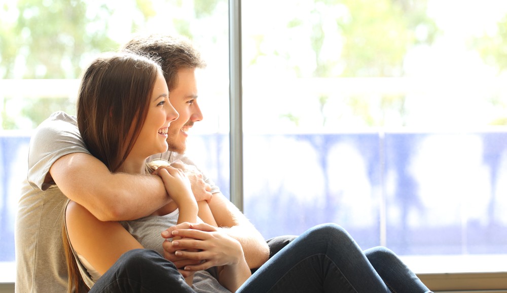 Couple looking at a windows lifespan in their home.