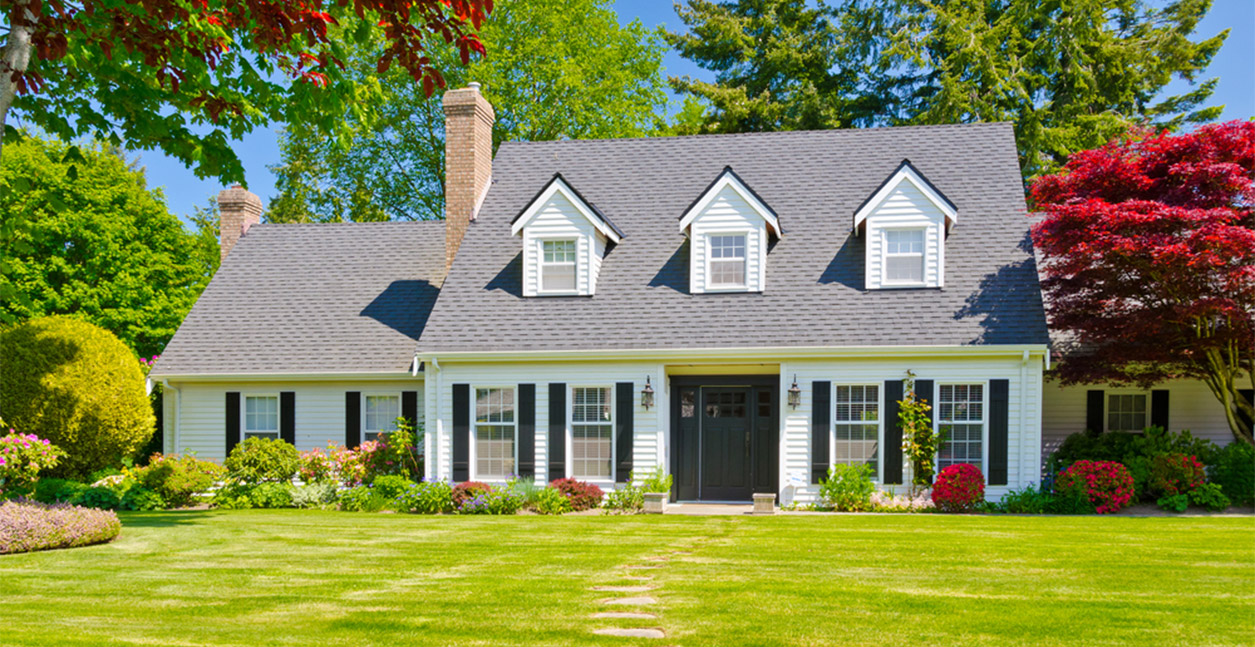 A gorgeous home with large windows and a modern front door.