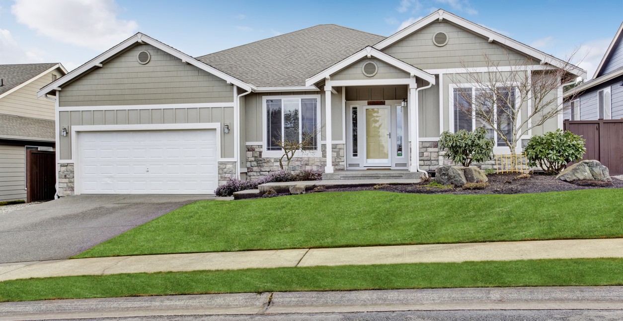 House exterior. View of entrance porch with walkway and garage.