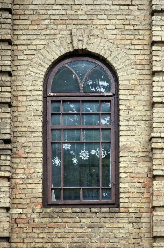 Window with white snowflakes hung inside