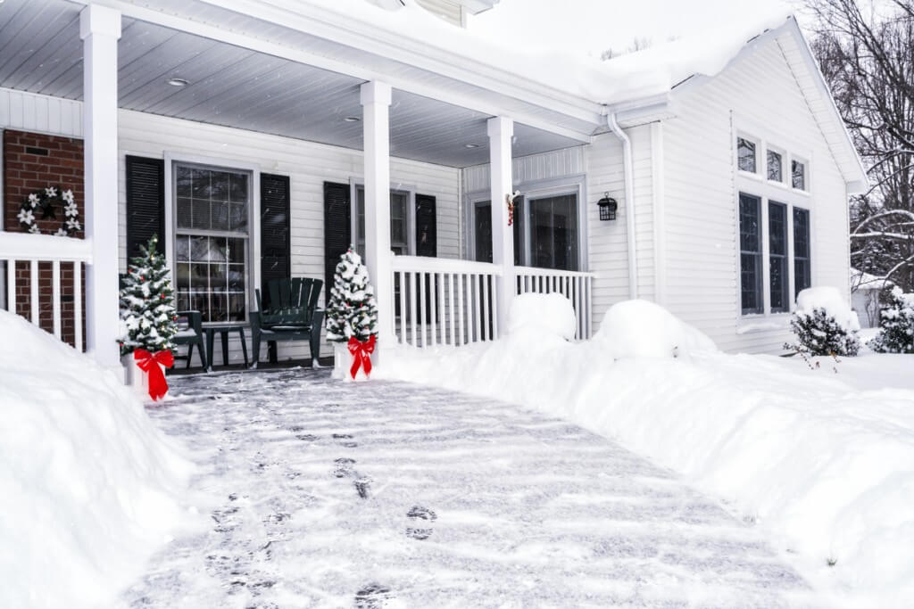 Winter Snow Footsteps on House Front Walkway