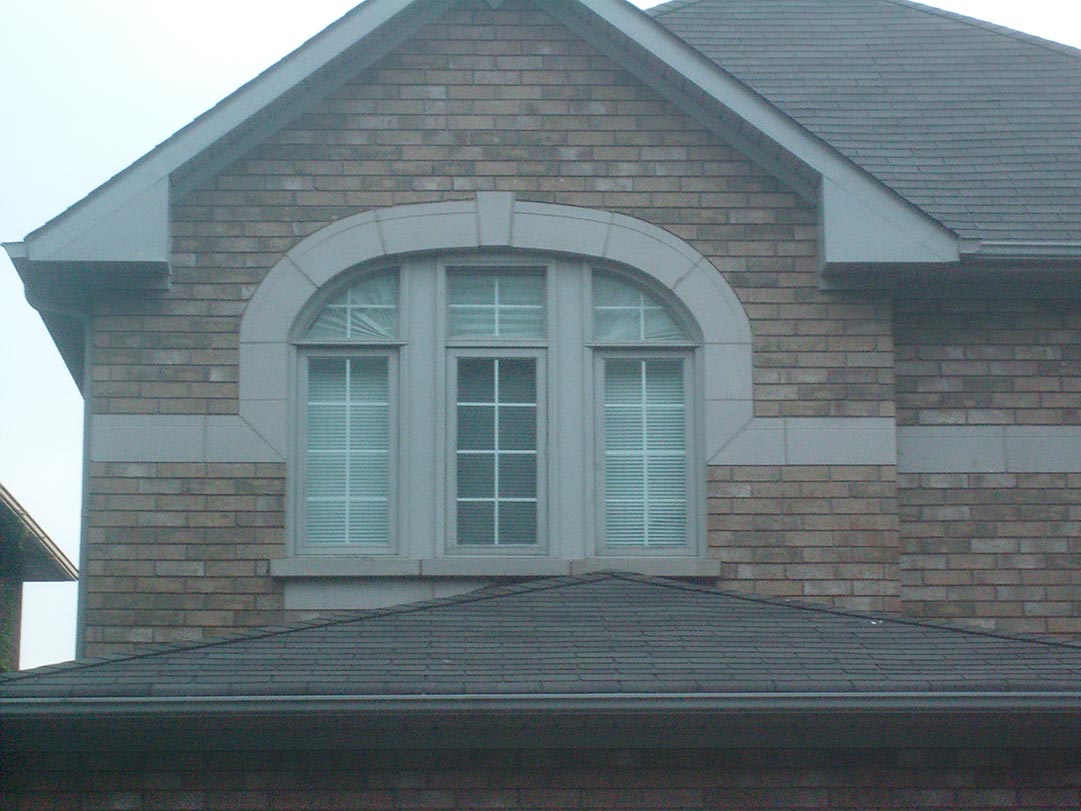 A combination of fixed and casement windows installed on a two-storey house.