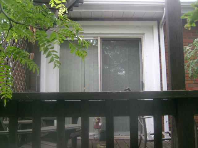 A house with a deck, showing the sliding patio door.