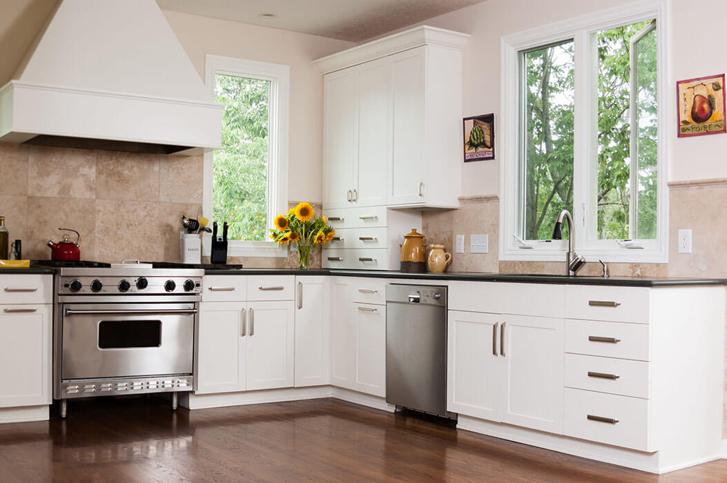 Contemporary kitchen with a replacement window over the sink and one casement window in the corner.