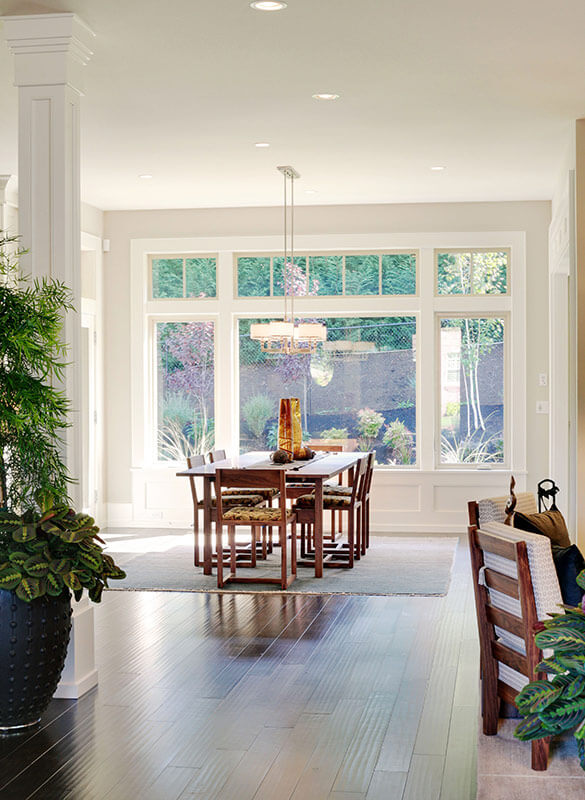 Kitchen with a dining room table and a large picture window looking onto the backyard.