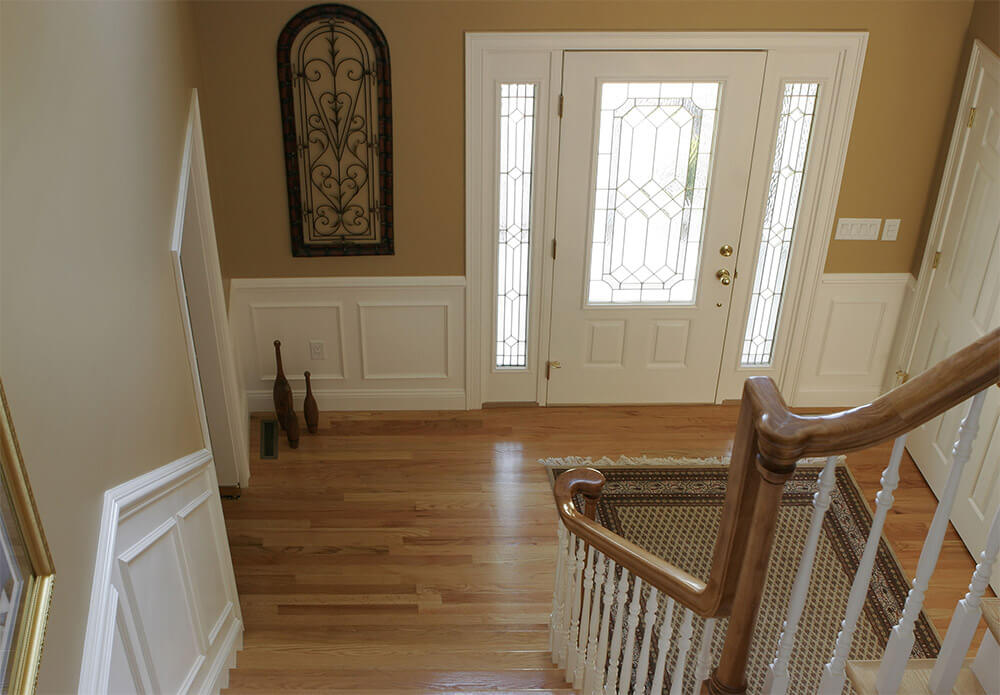 An interior view of a white steel entry door with glass inserts.