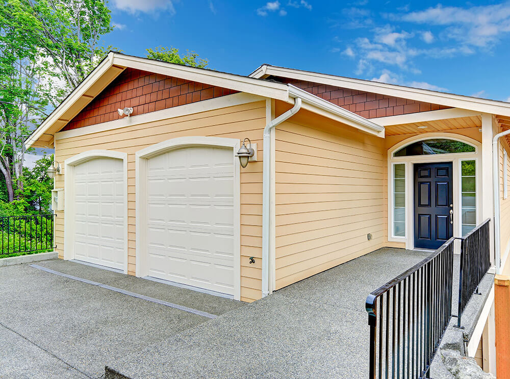 A modern home with peach siding, eavestrough, and fascia.