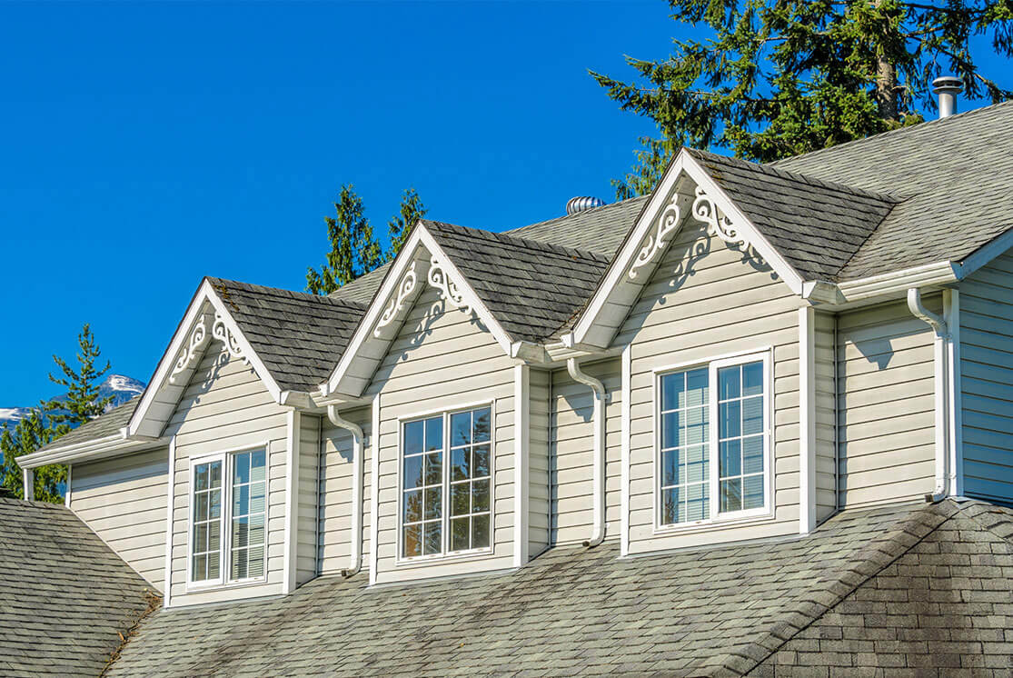 Town homes with large casement windows and grilles.